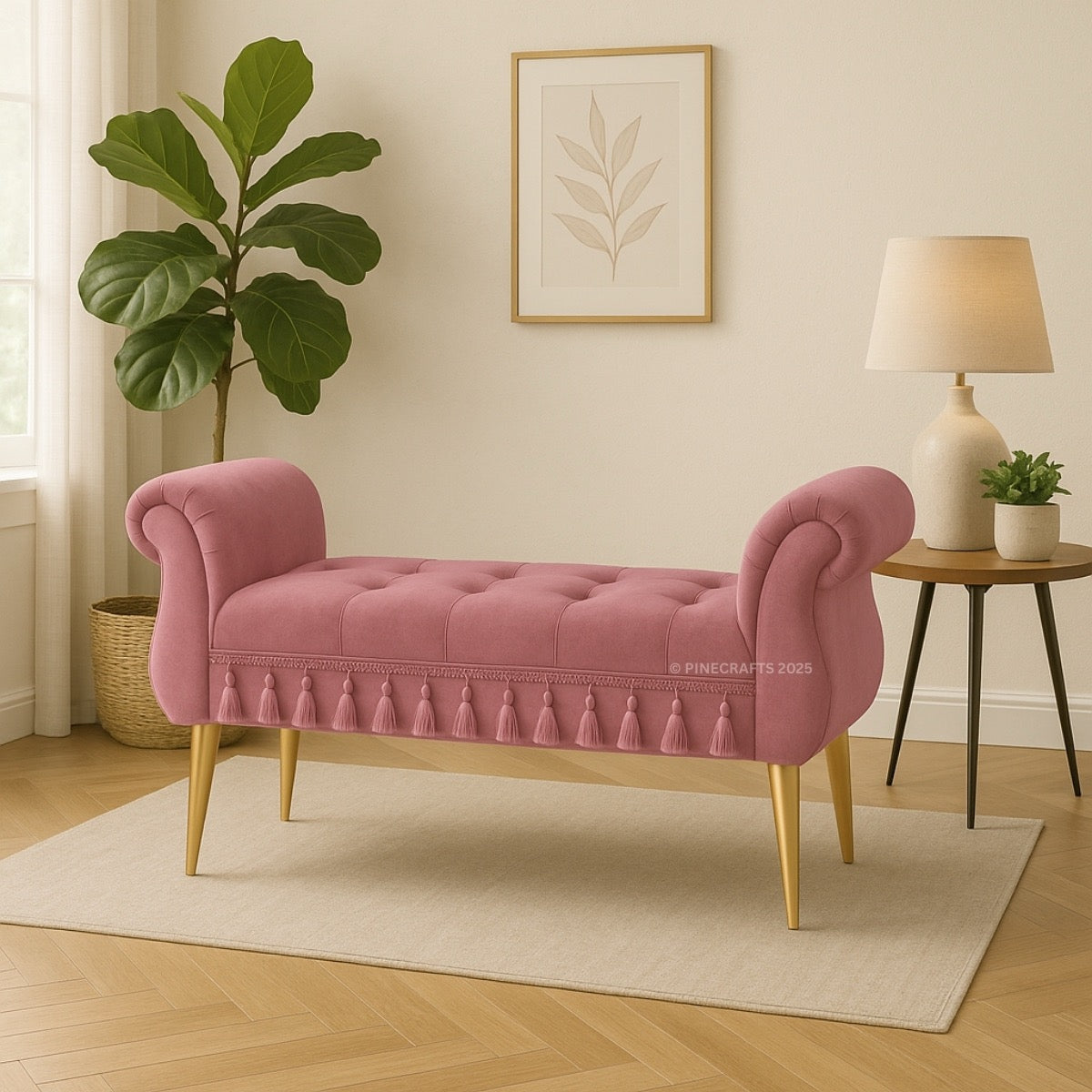 Pink tufted bench with gold legs in a room with a plant, lamp, and wall art.